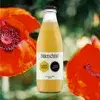A bottle of Bitterschön Lemon Spritz, labeled "Natural Ingredients" and "Alcohol-Free," set against a background of vibrant red poppies.